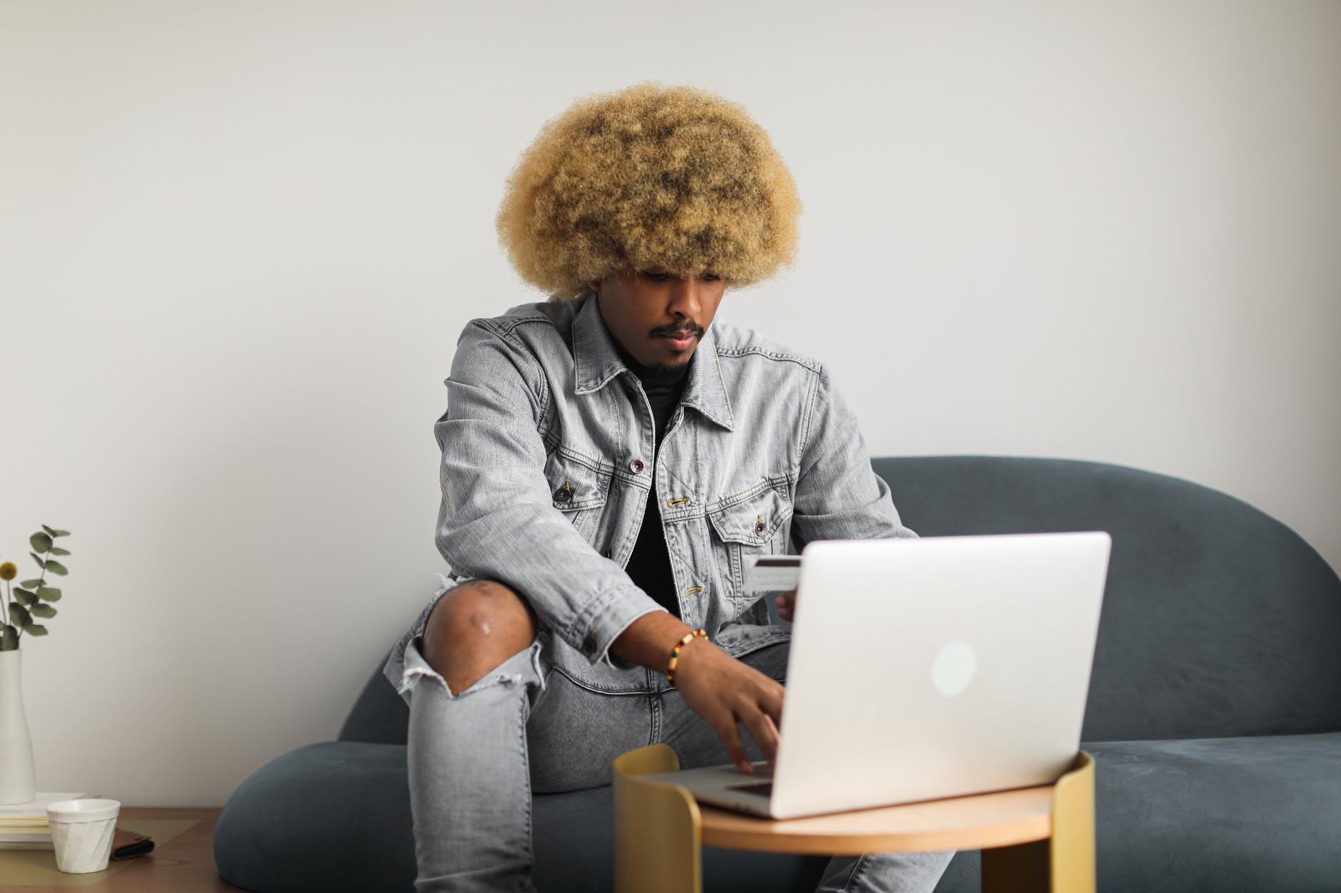 man using laptop and bank card for online payment